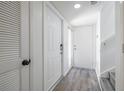 Bright foyer with hardwood floors, white doors, and staircase leading to the upper level at 498 Lakeview Dr # 45, Palm Harbor, FL 34683