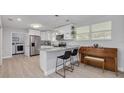 Bright kitchen features white cabinets, stainless steel appliances, and granite countertops with barstool seating at 505 Broxburn Ave, Temple Terrace, FL 33617