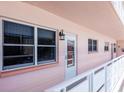 Hallway featuring a white railing and several windows, providing natural light and exterior views at 6025 Shore S Blvd # 408, Gulfport, FL 33707