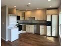 Well-lit modern kitchen with tile floors, custom cabinets and updated appliances at 6383 Biscayne, North Port, FL 34287
