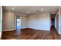 Spacious living room with wood-look tile, sliding doors to screened in porch at 6383 Biscayne, North Port, FL 34287