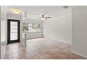 Bright and airy living room featuring tile flooring, a ceiling fan, and ample natural light at 7021 Blossom Ave, Tampa, FL 33614