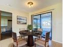 Cozy dining area with a round table and sliding door to the lanai at 7061 Denmark St, Englewood, FL 34224
