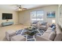 Bright living room features a cozy seating arrangement and large window at 7061 Denmark St, Englewood, FL 34224