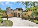Stunning home featuring a basketball hoop and a meticulously paved driveway leading up to its grand entrance at 8707 Silverthorn Rd, Seminole, FL 33777