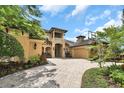 Beautiful home with a brick-paved driveway, lush landscaping, and an inviting entryway at 8707 Silverthorn Rd, Seminole, FL 33777