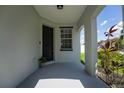 Charming covered front porch with elegant columns and a view of the landscaped yard at 9110 Lantern Oak Way, Land O Lakes, FL 34638