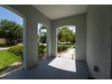 Covered front porch with elegant columns offering an inviting entryway to the home at 9110 Lantern Oak Way, Land O Lakes, FL 34638