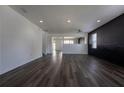 Spacious living room featuring sleek flooring, modern lighting, and freshly painted walls at 9110 Lantern Oak Way, Land O Lakes, FL 34638