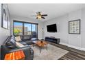 Cozy living room with black leather sofa, mounted TV, city views from a private balcony at 1108 N Franklin St # 602, Tampa, FL 33602