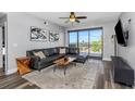 Modern living room with stylish leather sofa, balcony access, and neutral color palette at 1108 N Franklin St # 602, Tampa, FL 33602