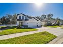 Charming two-story home with a large driveway and well-maintained green lawn at 11311 Striped Bass Ct, New Port Richey, FL 34654