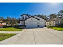Lovely two-story home with a three car garage, featuring a manicured lawn at 11311 Striped Bass Ct, New Port Richey, FL 34654