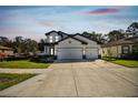 Lovely two-story home with a three car garage, featuring a manicured lawn at 11311 Striped Bass Ct, New Port Richey, FL 34654