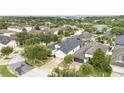 Aerial view of a home with a dark roof in a neighborhood surrounded by lush green trees at 12721 Avelar Creek Dr, Riverview, FL 33578