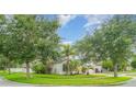Exterior view of home with lush landscaping and a well-manicured lawn on a sunny day at 12721 Avelar Creek Dr, Riverview, FL 33578