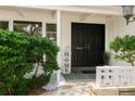 Inviting front entrance with black double doors and manicured landscaping at 2328 Harn Blvd, Clearwater, FL 33764