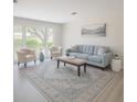 Bright living room featuring a large window and neutral decor at 2328 Harn Blvd, Clearwater, FL 33764
