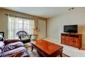 Bright living room featuring a large window, comfortable seating, and a TV at 2898 Thaxton Dr # 76, Palm Harbor, FL 34684