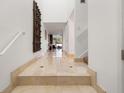 Elegant hallway with marble floors and staircase, leading to bright open living spaces at 301 2Nd N St # 14, St Petersburg, FL 33701