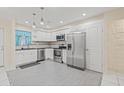 Bright kitchen features stainless steel appliances, white cabinets, and tile flooring at 3368 Ramblewood Pl # 37-D-1, Sarasota, FL 34237