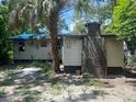 The back of the home has a large chimney and wood siding at 3518 16Th S Ave, St Petersburg, FL 33711