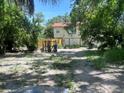 View of the backyard with partial fencing and some trees at 3518 16Th S Ave, St Petersburg, FL 33711