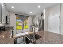 Well-equipped kitchen features granite countertops and stainless steel appliances at 5239 Fallen Leaf Dr, Riverview, FL 33578