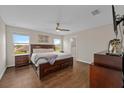 Spacious main bedroom with wood floors, a ceiling fan, and ample natural light at 5239 Fallen Leaf Dr, Riverview, FL 33578