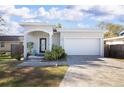Charming single-story home featuring a well-manicured lawn and a two-car garage with a brick-paved driveway at 5528 40Th N St, St Petersburg, FL 33714