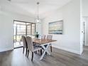 Chic dining room with modern table set and sliding glass doors to backyard at 5580 S Salford Blvd, North Port, FL 34287