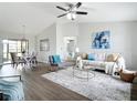 Open concept living room with dining area, modern decor, and hardwood floors at 5580 S Salford Blvd, North Port, FL 34287