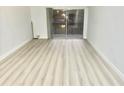 Bright living room featuring sliding glass doors, laminate floors, and neutral paint at 6344 Newtown Cir # B2, Tampa, FL 33615
