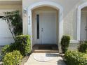 Inviting front door with arched entryway and manicured landscaping at 8158 Eagles Park N Dr, St Petersburg, FL 33709