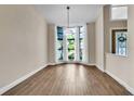 An empty formal dining area with a bay window and natural light offers a versatile living space at 910 Kingscote Ct, Safety Harbor, FL 34695