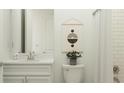 Well-lit bathroom featuring a vanity with a marble countertop, modern fixtures, and neutral decor at 9509 Minnow Ray Dr, Land O Lakes, FL 34638