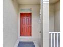Inviting front entrance featuring a bold red door and neutral exterior at 9907 Carlsdale Dr, Riverview, FL 33578