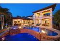 A stunning pool area with a waterfall, spa, outdoor kitchen, and covered patio, perfect for entertaining at 10930 Spring St, Largo, FL 33774