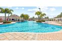 Resort-style pool featuring comfortable lounge chairs and lush tropical landscaping at 11830 Autumn Creek Dr, Riverview, FL 33569