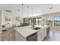 Bright kitchen featuring a large island, stainless steel appliances, and sliding doors to the backyard at 12821 Satin Lily Dr, Riverview, FL 33579