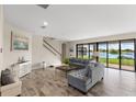 Spacious living room features a cozy seating area, staircase, and sliding glass doors with a view at 12821 Satin Lily Dr, Riverview, FL 33579