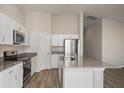 Bright kitchen with stainless steel appliances, white cabinetry, and an island for extra space at 14817 Summer Branch Dr, Lithia, FL 33547
