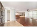 Spacious living room with hardwood floors, a ceiling fan, and a stone fireplace at 1741 Font Ln, Holiday, FL 34691