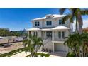 Beautiful two-story home with covered balconies, a three car garage, and meticulous landscaping at 17715 Wall Cir, Redington Shores, FL 33708