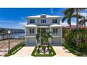Stunning two-story home with manicured lawn and a three car garage at 17715 Wall Cir, Redington Shores, FL 33708