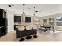 Modern eat-in kitchen featuring black cabinets, a large island, and stainless steel appliances at 2120 Gwynhurst Blvd, Wesley Chapel, FL 33543