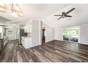 Open-concept living room featuring a ceiling fan, hardwood floors, and sliding glass doors to the outside at 2121 Odessa Gardens Ln, Odessa, FL 33556