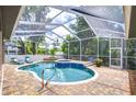 Inviting screened-in pool and spa area surrounded by brick pavers and lush greenery, perfect for relaxation and entertainment at 2504 Oak Landing Dr, Brandon, FL 33511