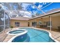 Beautiful screened-in pool with a connected spa and an outdoor kitchen for luxurious outdoor living and entertaining at 2504 Oak Landing Dr, Brandon, FL 33511