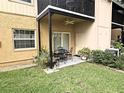 Covered back patio featuring a ceiling fan and comfortable seating, perfect for outdoor dining and relaxing at 3810 N Oak Dr # N31, Tampa, FL 33611